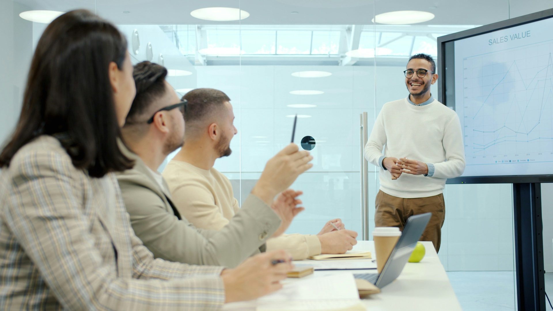 Man presenting to colleagues in a modern office setting